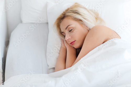 young woman sleeping in bed at home bedroom
