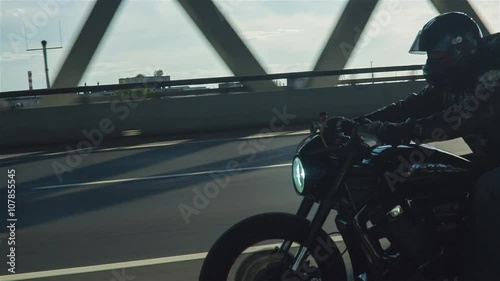 Man Riding Motorcycle In Asphalt Road