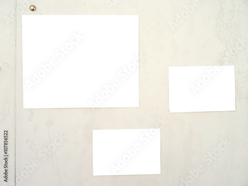 Papers on cream color wall with clipping path