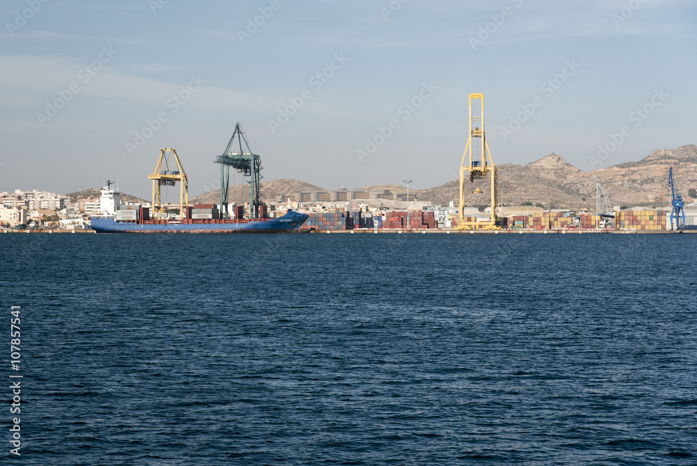 Container cranes loading a ship in the port