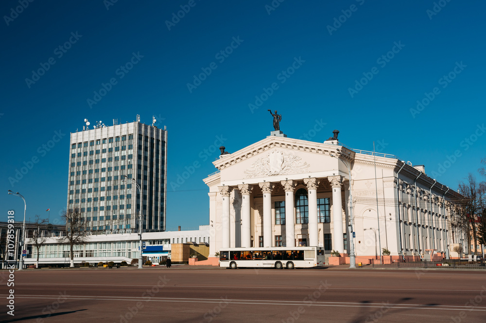Naklejka premium Bus Moving Along Street Near Building Of Gomel Regional Drama Th