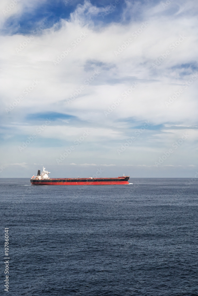 Vertical image of a cargo ship in the sea Vertical image of a cargo ship in the sea