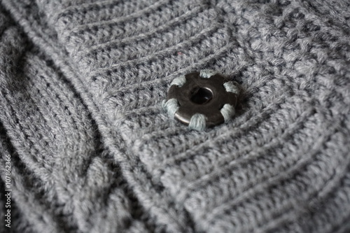  Detail of gray metal buttons fastening the woolen sweater