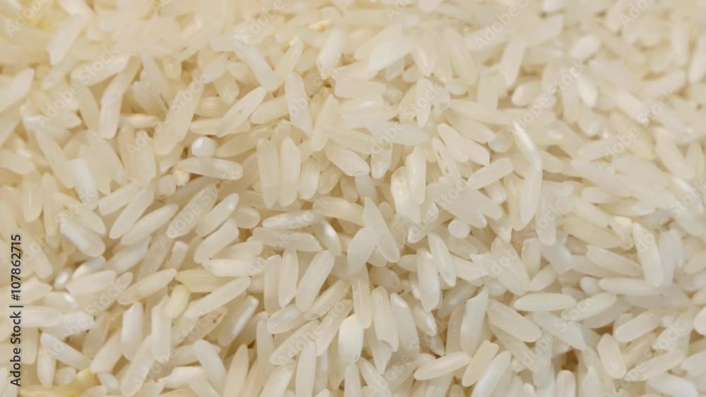 4k Raw rice rotating smoothly under studio lighting, looped video 4k Raw rice rotating smoothly under studio lighting, looped video