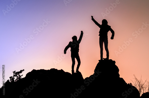 Two young girls on top during sundown.