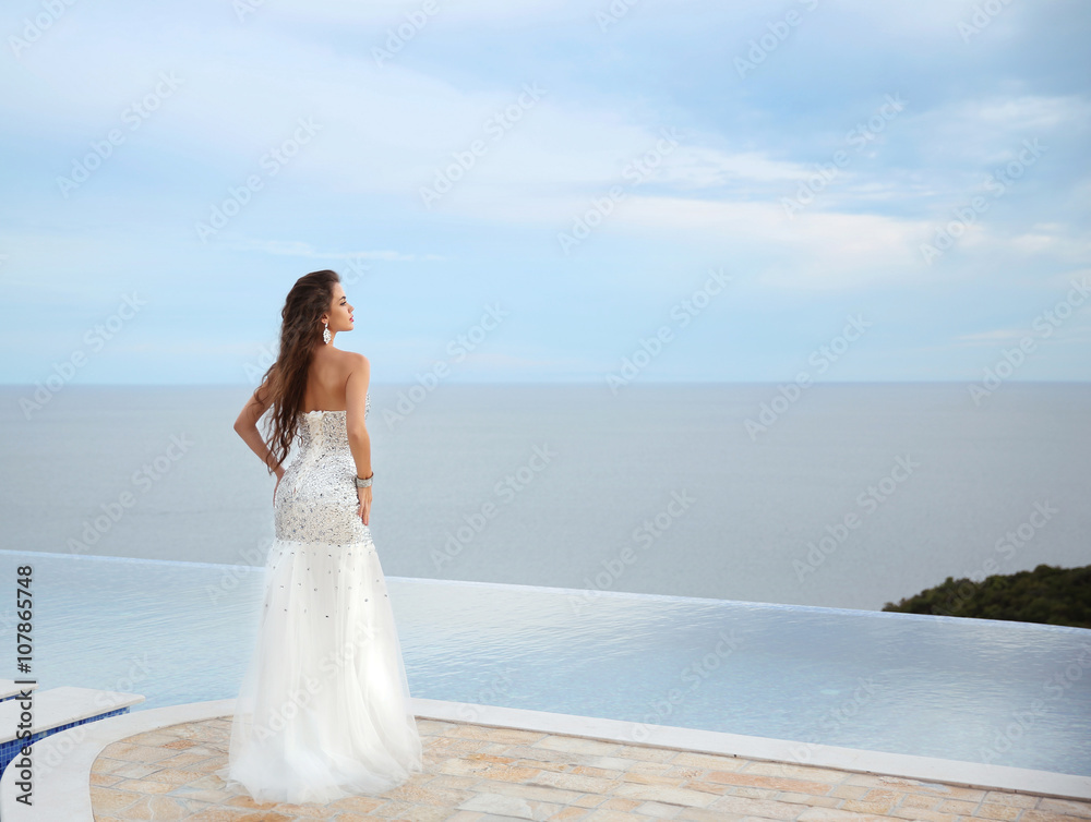 Beautiful bride girl in beaded wedding dress. Summer holiday fas Beautiful bride girl in beaded wedding dress. Summer holiday fas