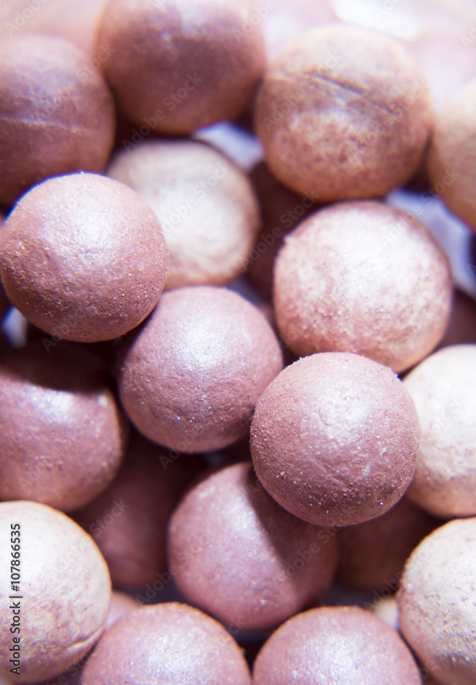 Balls of blush close-up, makeup. Texture of colored balls for makeup. Balls of blush close-up, makeup. Texture of colored balls for makeup.
