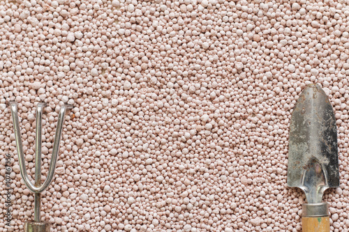 Pink background with mineral fertilizers balls.