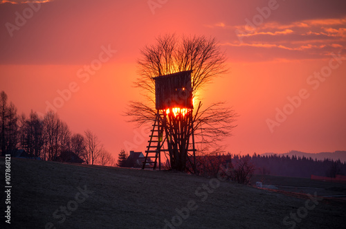 Hunting tower on colorful sunrise