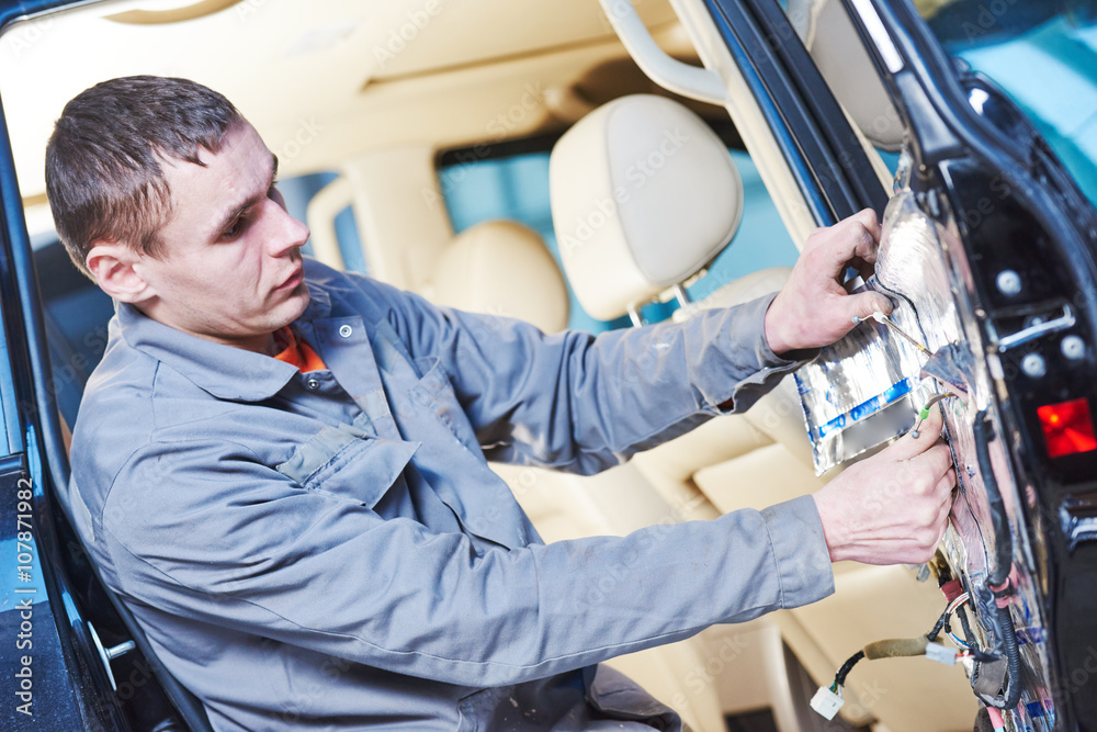auto mechanic placing the damping mats on car door auto mechanic placing the damping mats on car door