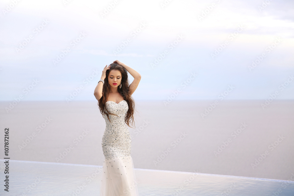 Beautiful fashion bride girl in beaded wedding dress. Summer hol Beautiful fashion bride girl in beaded wedding dress. Summer hol
