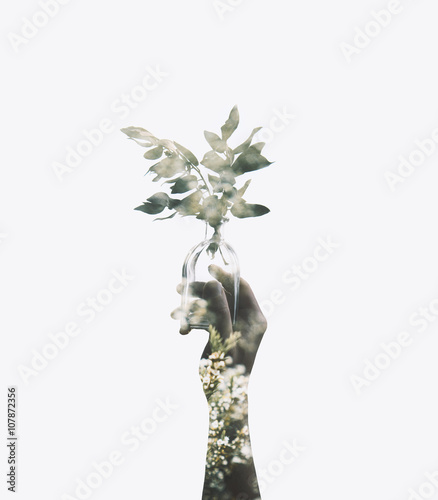 Double exposure with man’s hand holding glass jar with branch plant, filtered image photo