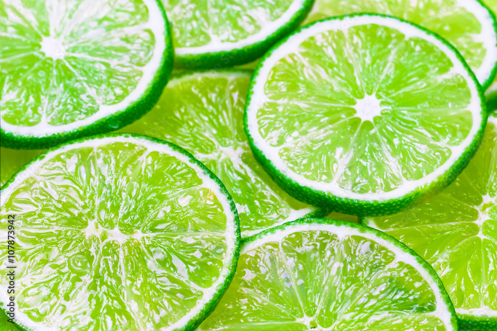 Green background with citrus-fruit of lime slices