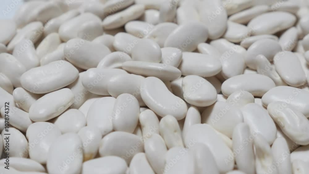 White raw beans also known as haricot beans food close-up 4K 2160p 30fps UltraHD food video- Shallow DOF Phaseolus vulgaris white dry beans organic food background 4K 3840X2160 UHD footage White raw beans also known as haricot beans food close-up 4K 2160p 30fps UltraHD food video- Shallow DOF Phaseolus vulgaris white dry beans organic food background 4K 3840X2160 UHD footage