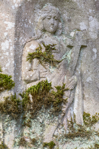Engraved sculpture of saint on grave © Falk