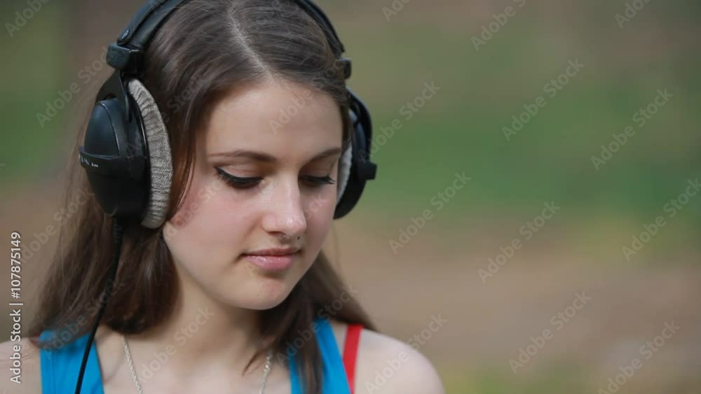 close-up of young teenage woman in professional hradphones close-up of young teenage woman in professional hradphones