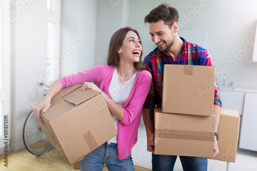 Couple with unpacked boxes in new home