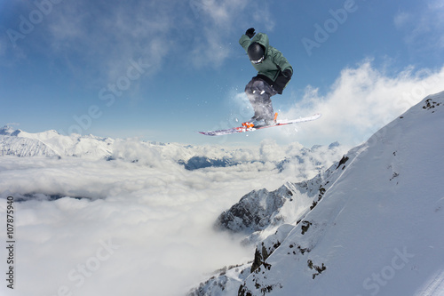 Ski rider jumping on mountains. Extreme ski freeride.