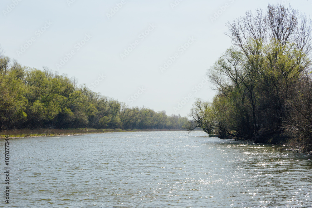 Landscape with views of the river, the trees on the shore and blue sky. Landscape with views of the river, the trees on the shore and blue sky.