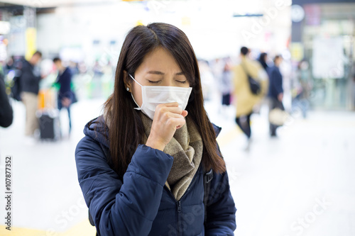 Woman feeling sick and wearing face mask