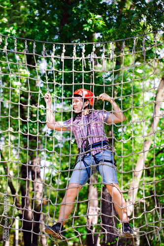 adventure climbing high wire park - people on course in mountain