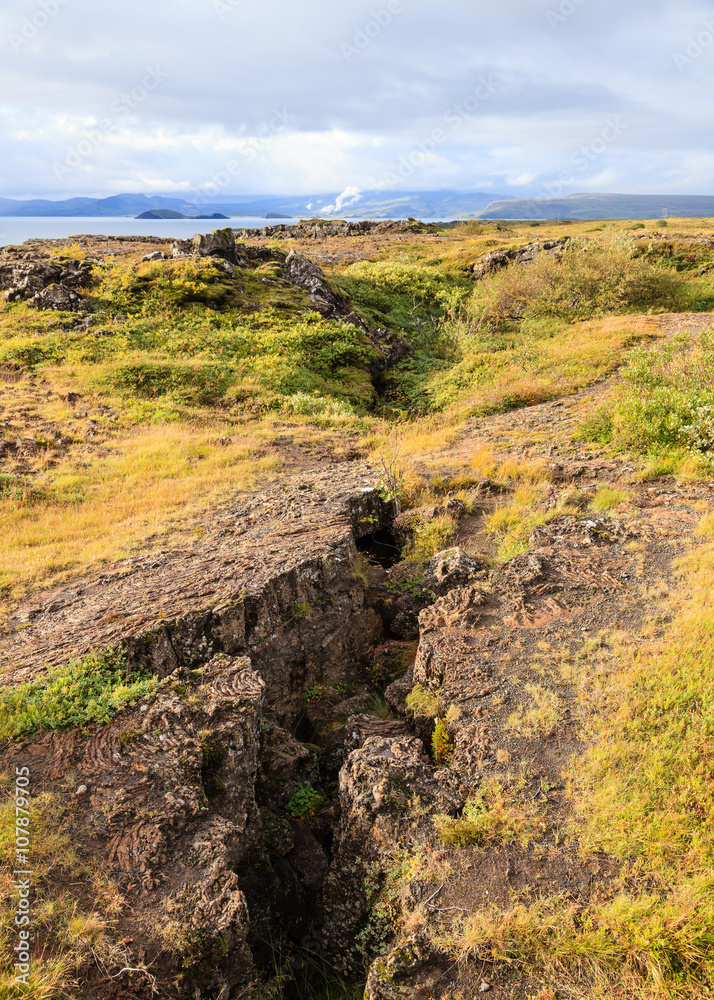 Tectonic Plates.  The mid Atlantic tectonic plates dividing Europe from America are viewed in the Thingvellir National Park in Iceland.  Thingvellir is a World Heritage Site.