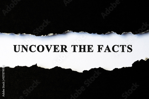 Uncover the facts concept phrase under torn paper