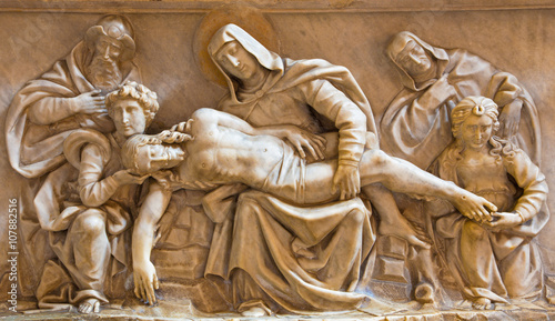 Rome - The Pieta marble relief in church Basilica di Santa Maria del Popolo and chapel Cappella Basso della Rovere (1483) by the school of Andrea Bregno. photo