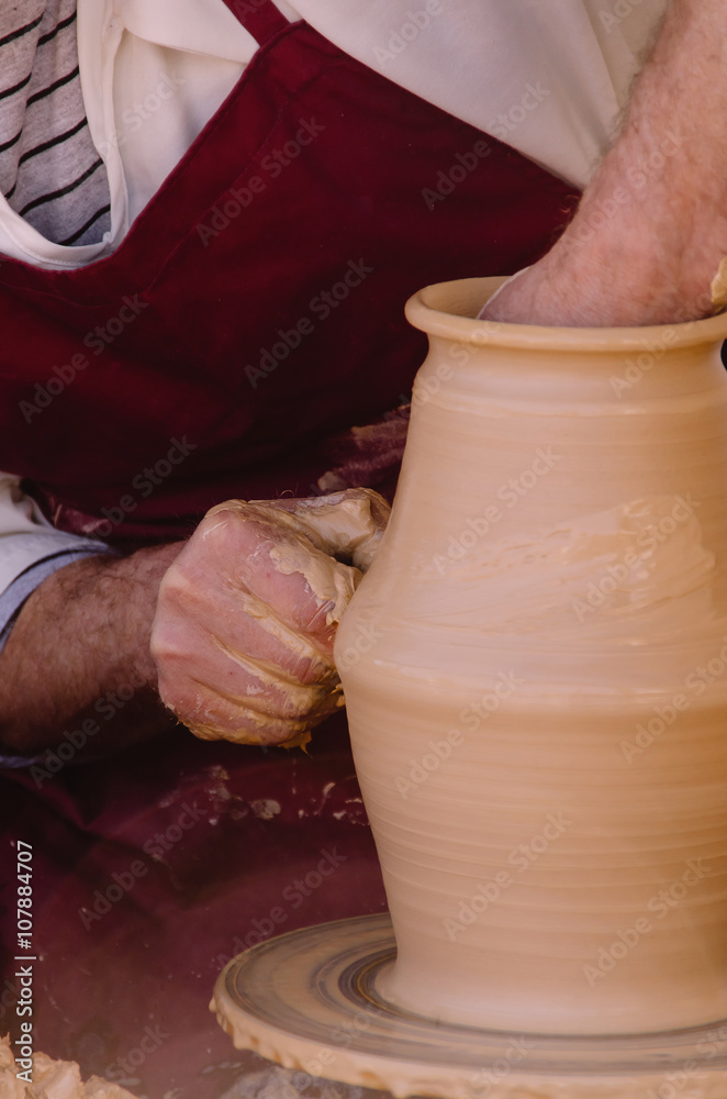 Detail on potter hands modeling a vase Detail on potter hands modeling a vase