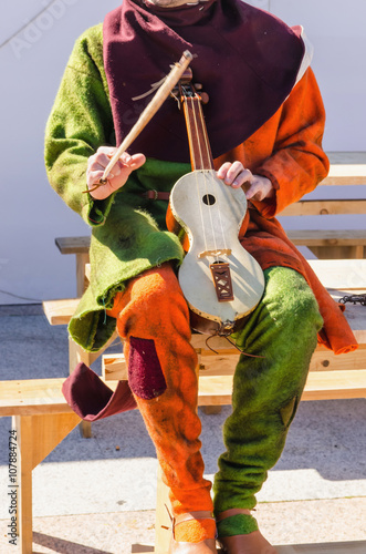 Unrecognizable musician playing rebec photo