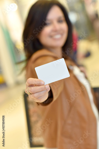 Portrait of woman holding card in shopping mall
