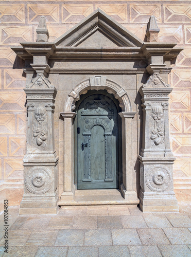 Old door in a stone building of castle in Cesis town