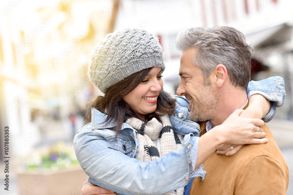 Mature man holding girlfriend in arms Mature man holding girlfriend in arms