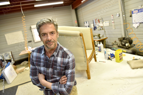 Portrait of successful upholsterer in workshop photo