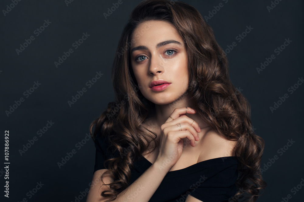 Fashion portrait of young woman with magnificent curly hair. Bru