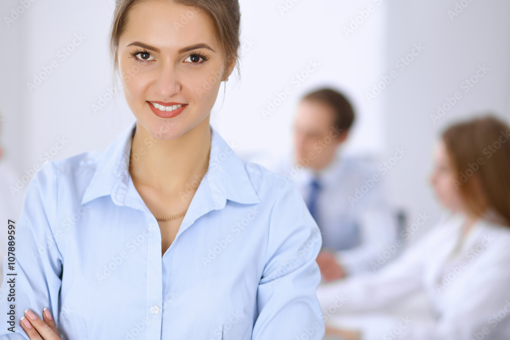 Beautiful business woman on the background of business people during meeting Beautiful business woman on the background of business people during meeting