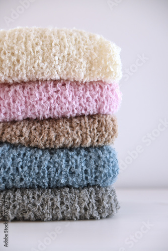Pile of folded soft hand knit clothes