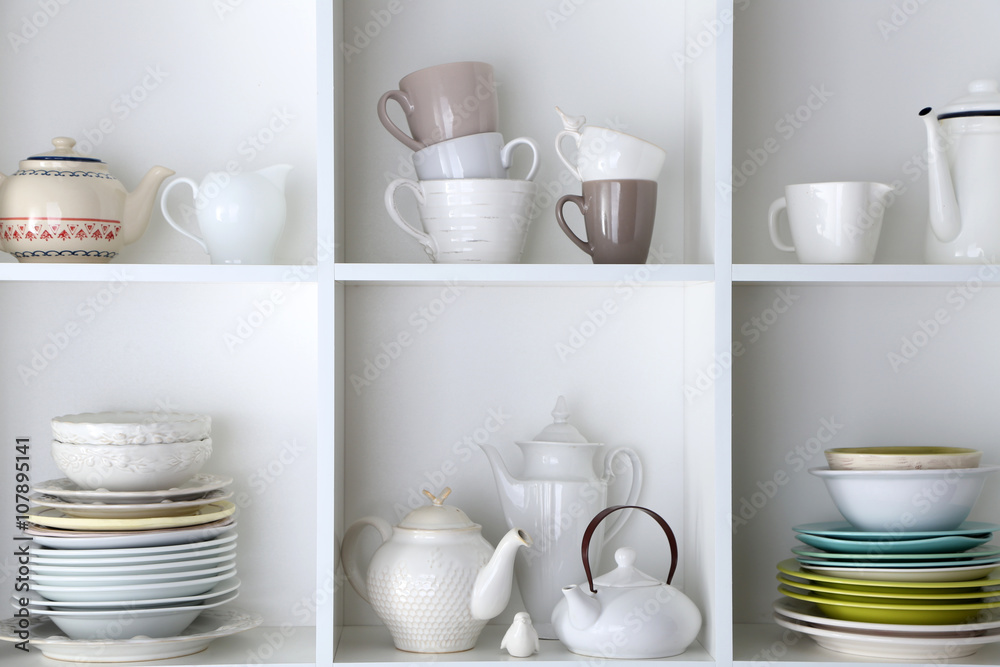 Different clean dishes on wooden shelves Different clean dishes on wooden shelves
