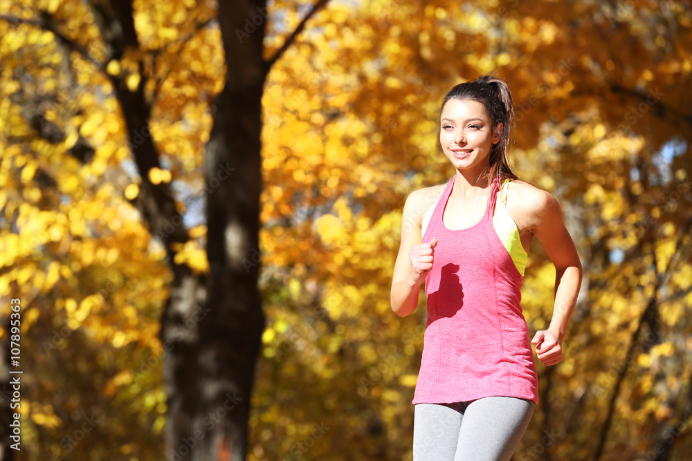 Young beautiful woman jogging in autumn park Young beautiful woman jogging in autumn park