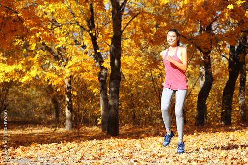 Young beautiful woman jogging in autumn park © Africa Studio