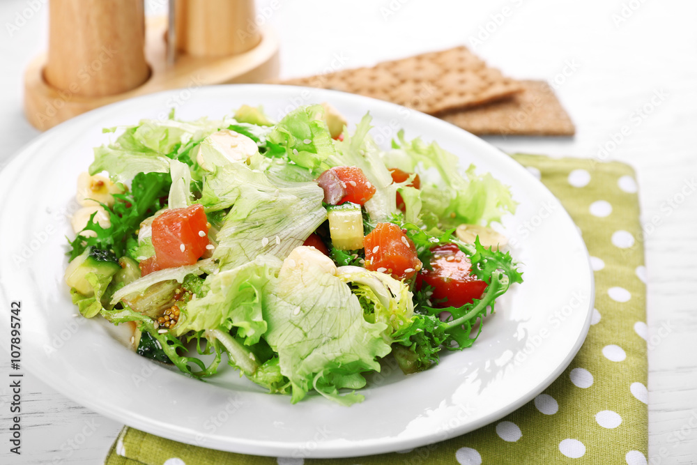 Tasty salmon salad on light wooden background Tasty salmon salad on light wooden background
