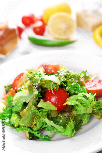 Tasty salmon salad on light wooden background