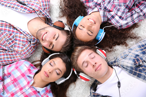 Two teenager couples listen...
