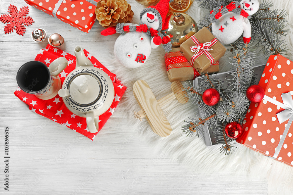 Christmas background. Decorations, cones, gift boxes on white wooden background