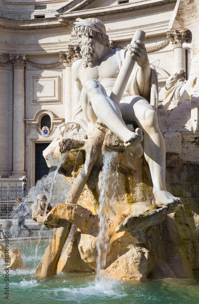 Rome - Piazza Navona in morning and Fontana dei Fiumi by Bernini and Santa Agnese in Agone church. The statue of Ganga river by Claude Poussin