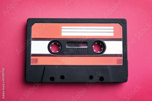 Old audio cassette on red background