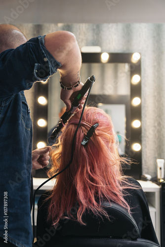 Beautiful woman getting haircut by hairdresser.