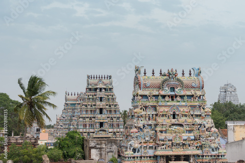 Trichy, India - October 15, 2013: Five gopurams of the temple in one shot. Four pastel colored with plenty of statues including the main Ranganathar depiction of Vishnu resting on the snake.