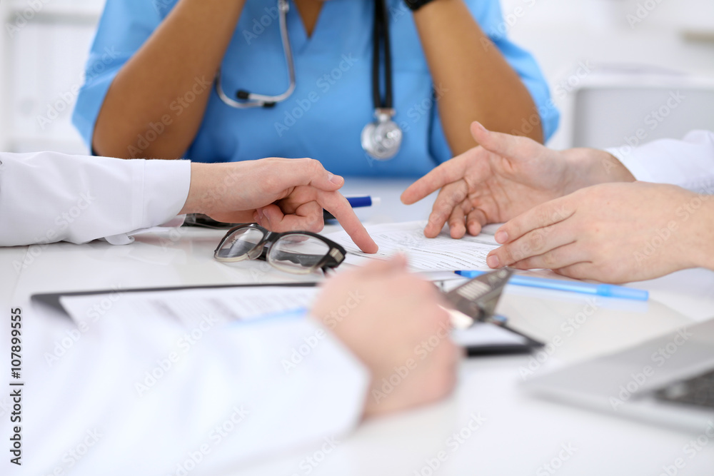 Group of doctors discuss at meeting Group of doctors discuss at meeting