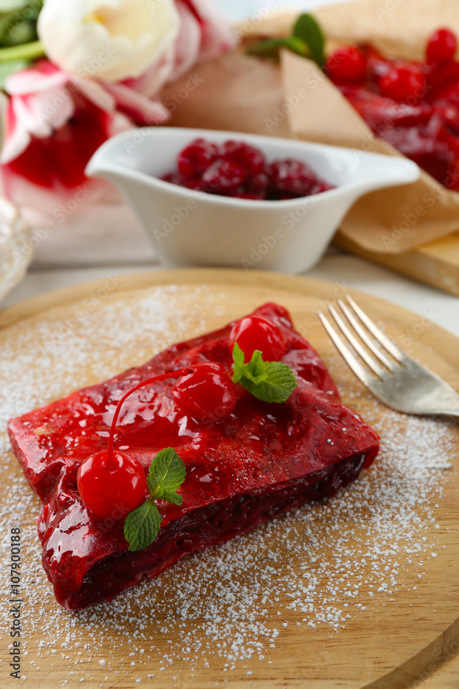 Cherry strudel with mint on cutting board Cherry strudel with mint on cutting board